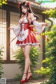 A woman in a red and white dress standing in front of a window.